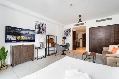 a living room with a couch and a table at Stylish Studio Retreat Heart of Downtown Dubai in Dubai