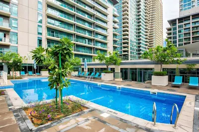 an empty swimming pool in a large apartment building at Spacious 2 Bedroom plus Office Prime Dubai Marina in Dubai