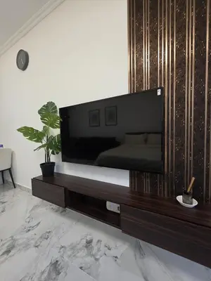a living room with a large flat screen tv at Luxury Studio in JLT near Metro & Lake View in Dubai