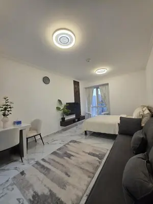 a living room with a bed and a couch at Luxury Studio in JLT near Metro & Lake View in Dubai
