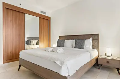 a bedroom with a large bed with two towels on it at FIRST CLASS 1BR Luxury Marina Retreat in Dubai