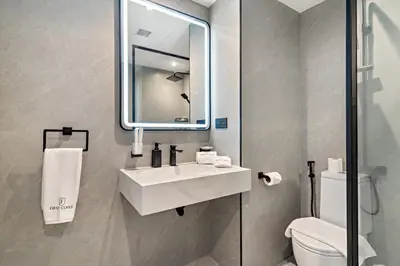 a bathroom with a sink and a mirror and a toilet at FIRST CLASS 1BR Luxury Marina Retreat in Dubai