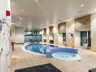a large swimming pool in a building with at FIRST CLASS 1BR Luxury Marina Retreat in Dubai