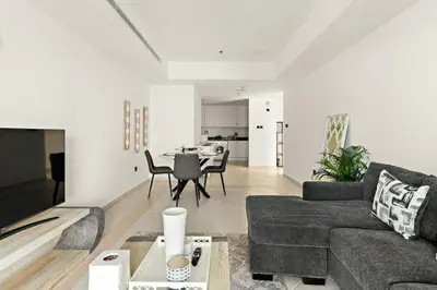 a living room with a couch and a table at FIRST CLASS 1BR Luxury Marina Retreat in Dubai