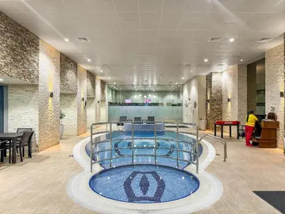a pool in the middle of a lobby at FIRST CLASS 1BR Luxury Marina Retreat in Dubai