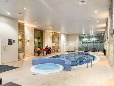 a large swimming pool in a building with a pool at FIRST CLASS 1BR Luxury Marina Retreat in Dubai