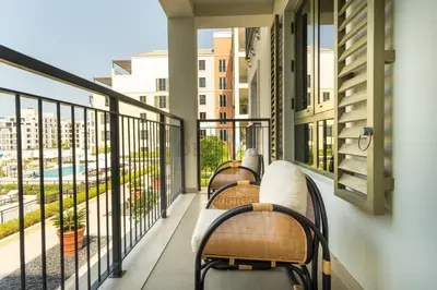 a balcony with benches and a view of a city at Seafront 2BR, Within Walking Distance to La Mer Beach, Short Drive Away from Mercato Mall, La Sirene Building 2, La Mer by Deluxe Holiday Homes in Dubai