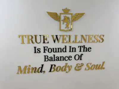 a cross with the words true wellness is found in the balance of mind body at Miracle Luxury Studio in Dubai