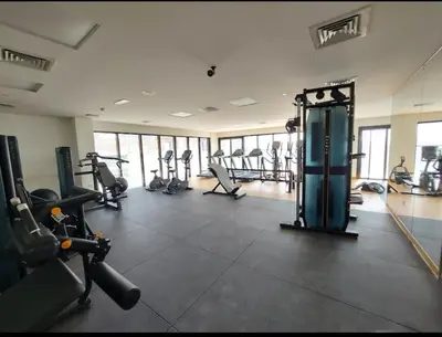 a gym with treadmills and machines in a room at Dubai heaven in Dubai