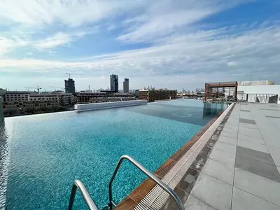a large swimming pool on the roof of a building at Dubai heaven in Dubai