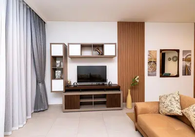 a living room with a television and a couch at Luxury stay at Downtown Dubai-Walk to Burj Khalifa in Dubai