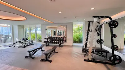 a gym with treadmills and treadles in a building at Stylish 2BR Beachfront Pool&Gym Access in Dubai
