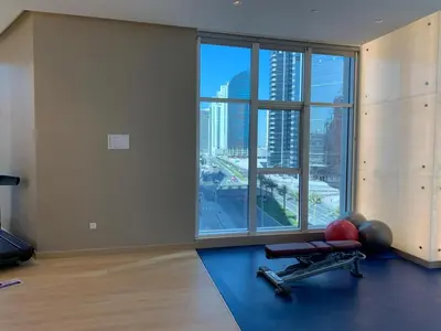 an empty room with a gym with a large window at Mahenti · Luxury Living at Its Finest in Dubai