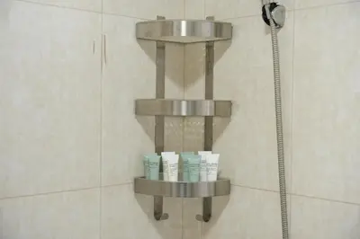 a shelf in a shower with three rolls of toiletries at Stylish Marina Stay Near Bla Bla club & JBR Walk in Dubai