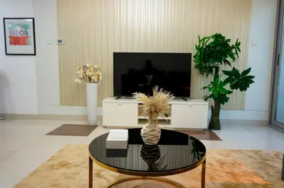 a living room with a tv and a glass table at Stylish Marina Stay Near Bla Bla club & JBR Walk in Dubai