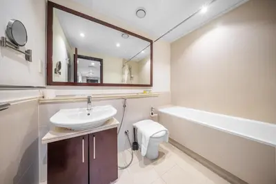 a bathroom with a sink and a tub and a toilet at Prime Dubai Marina Spot - Beach, Dining and leisure in Dubai