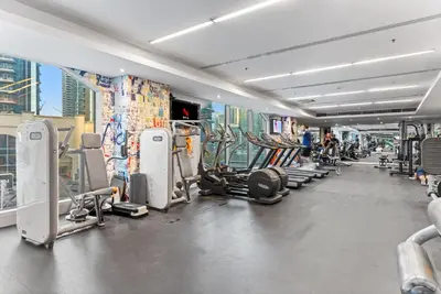 a gym with treadmills and machines in a building at Prime Dubai Marina Spot - Beach, Dining and leisure in Dubai