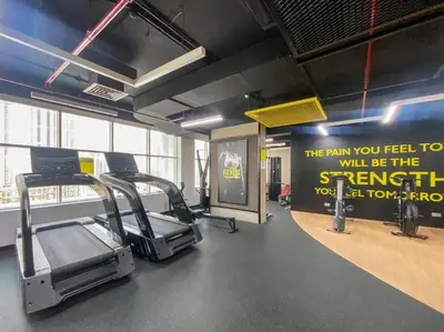 a gym with cardio equipment and a sign on the wall at Luxury Stay - Walk to Dubai Mall & Burj Khalifa 21 in Dubai