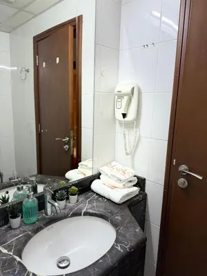 a bathroom with a sink and a phone at Luxury Stay - Walk to Dubai Mall & Burj Khalifa 21 in Dubai
