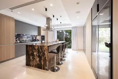 a kitchen with a counter with a bar with stools at Villa with Private Pool in Palm Jumeirah in Dubai