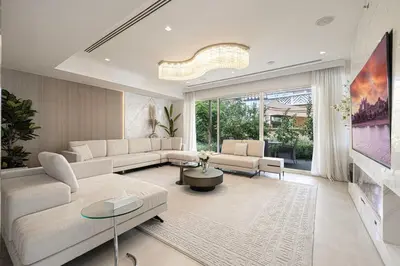 a living room with white furniture and a large window at Villa with Private Pool in Palm Jumeirah in Dubai