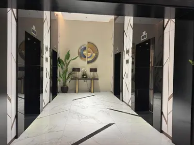 a hallway with black doors and a potted plant at Zada Tower, Business Bay in Dubai