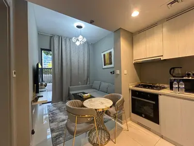 a kitchen and living room with a table and chairs at Zada Tower, Business Bay in Dubai