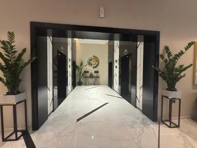 a large mirror in a room with two potted plants at Zada Tower, Business Bay in Dubai