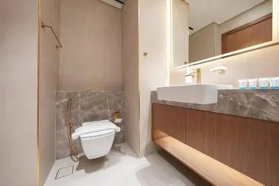 a bathroom with a white toilet and a sink at Designer Studio Retreat with Jacuzzi & Canal Views in Dubai
