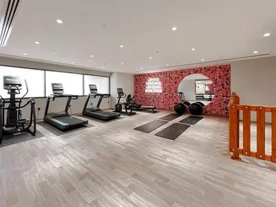 a gym with treadmills and cardio equipment in a room at Front Burj View - 6min to Dubai Mall - Pool - Gym in Dubai