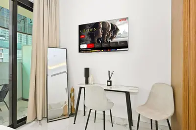 a dining room with a table and two chairs at Riviera Azure Gateway Superior- 10min to Burj Khalifa, Dubai Mall and Airport and 20min to Marina in Dubai