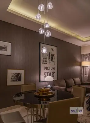 a living room with a couch and a table at Lux One Bedroom at Damac paramount in Dubai
