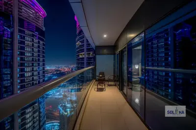 a room with a view of a city at night at Lux One Bedroom at Damac paramount in Dubai