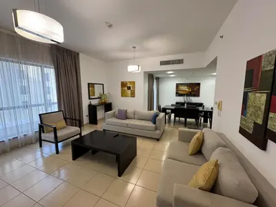 a living room with a couch and a piano at JBR - spacious and neat 3br apt in Shams 1 in Dubai