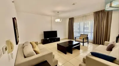 a living room with two couches and a television at JBR - spacious and neat 3br apt in Shams 1 in Dubai