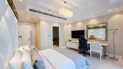 a bedroom with a bed and a desk and a television at BEACH FRONT I 2 Bedroom in TRIDENT JBR Dubai Marina I Palm & Sea Views I Amazing Balcony in Dubai