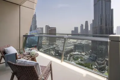 a balcony with chairs and a view of a city at Frank Porter - Burj Vista Tower 1 in Dubai