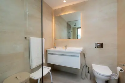 a bathroom with a sink and a toilet and a mirror at Scenic - Contemporary - Marina Getaway in Dubai