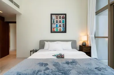 a bedroom with a bed and a picture on the wall at Scenic - Contemporary - Marina Getaway in Dubai