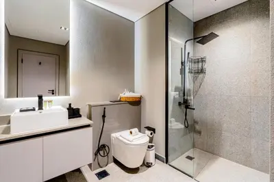 a bathroom with a shower and a toilet and a sink at Luxurious 1BR Retreat in MAG City Dubai in Dubai