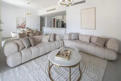 a living room with a large couch and a table at Frank Porter - Jadeel 3 in Dubai