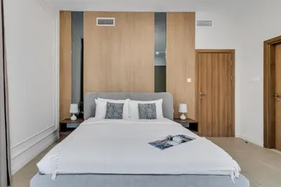 a bedroom with a large white bed with two lamps at Luxury 1BR in Sulafa Tower by EE Holiday Homes in Dubai