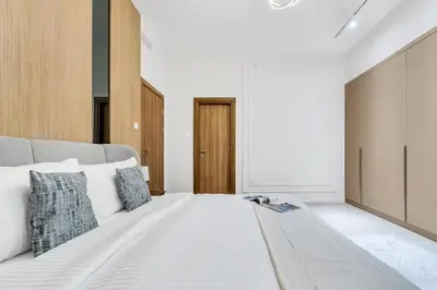 a bedroom with a large white bed with pillows at Luxury 1BR in Sulafa Tower by EE Holiday Homes in Dubai