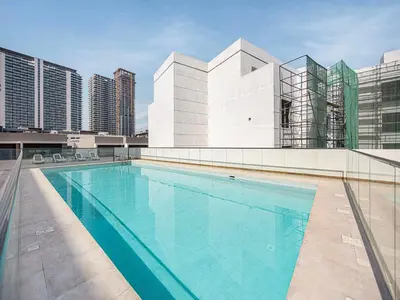 a swimming pool on the roof of a building at Livin' Holidays - Studio - Stylish flat in JVC in Dubai