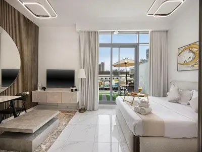 a hotel room with a bed and a tv and a living room at Livin' Holidays - Studio - Stylish flat in JVC in Dubai