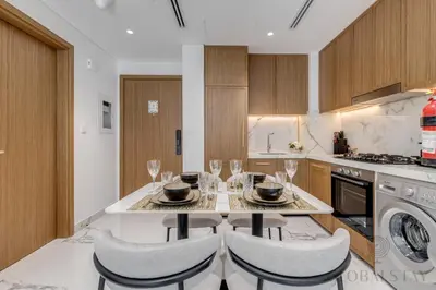 a kitchen with a table with wine glasses on it at GlobalStay Azizi Riviera 67 Apartments Dubai in Dubai