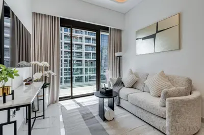 a living room with a couch and a table at GlobalStay Azizi Riviera 67 Apartments Dubai in Dubai