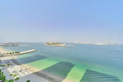 an aerial view of a beach and the ocean at Luxury 2BR Beach Isle With Palm Views and Beach Access in Dubai