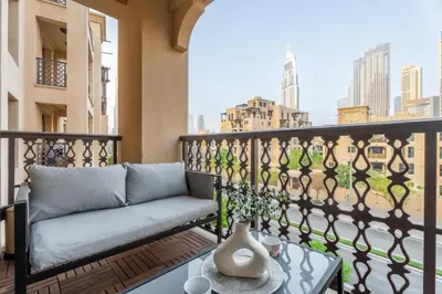 a couch on a balcony with a view of the city at GuestReady - 2BR | Downtown Bliss with Burj View in Dubai