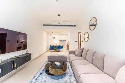 a living room with a couch and a table at HAVN - New 2 Bedroom in Binghatti Amber, JVC in Dubai